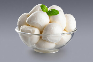 Bowl with mozzarella cheese on gray background. With clipping path.