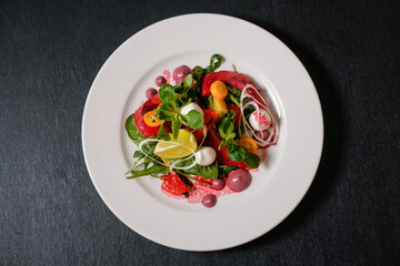 Salad with salmon, beets, lemon and herbs.