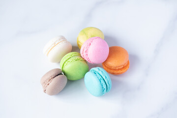 multicolored macarons on marble background
