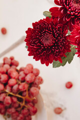 Fototapeta premium Red flowers with red grape grape
