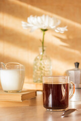 Cup with coffee, milk. Flower in the vase. Breakfast. Sunny day. 