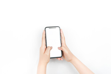 holding a smartphone using two hands like it's typing a chat. a smartphone with a blank white screen used for advertising mockup.