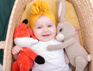 cute baby girl posing. A fashionable Baby is photographed for advertising.Fashionable baby in a yellow turban