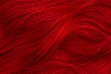 Red hair. Background hair closeup. Female long red-haired close-up as a background. Beautifully laid carroty wavy shiny curls. Hair coloring.Hairdressing procedures. Copy space with space for text.