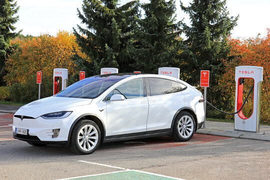 White Tesla Model X Electric SUV Charging Battery at Supercharger