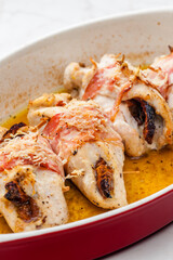 chicken rolls stuffed with dry tomatoes in bacon