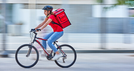 Bike messenger courier delivering in city with motion blur