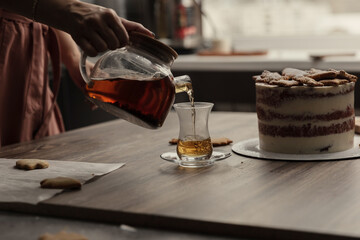 Chef or baker decorating cake with white whipped cream.Soft fokus