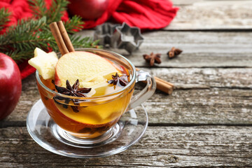 Hot mulled cider on wooden table. Space for text