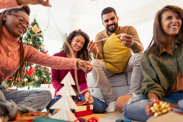Group of friends wrapping Christmas presents