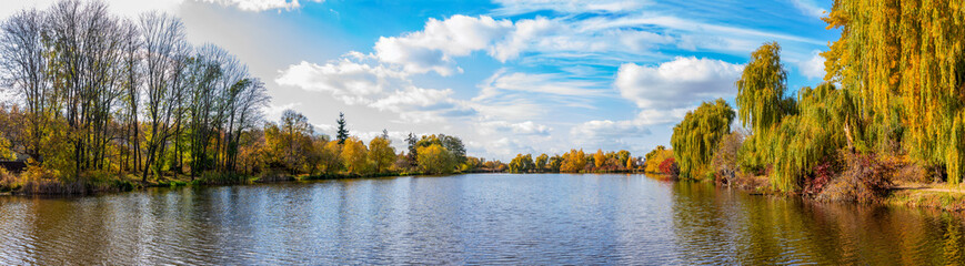 Fototapeta premium Panorama of autumn lake on a bright sunny day