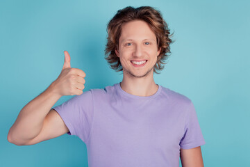 Photo of handsome guy smile raise thumb fingers up advertise choice feedback isolated teal color...