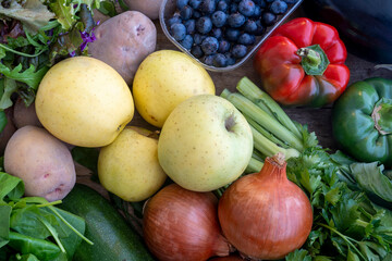 Fresh mixed bio vegetable and fruits in wooden basket harvested in the morning. Bio box from...
