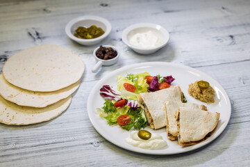 chicken quesadilla with rice, beans, salad, chalapenos and salsa