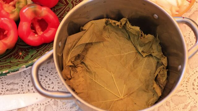 People cook dolma food.
Grape leaves stuffed with minced meat.