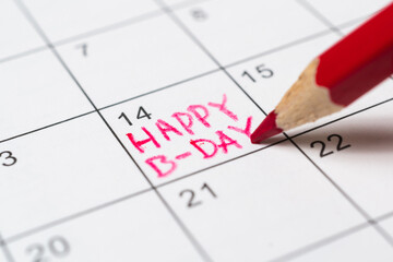Person marks the date on the calendar as a birthday reminder