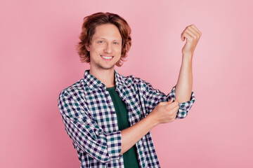 Photo of young handsome man happy positive smile correct fix sleeves shirt isolated over pink color background