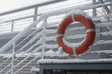 a lifebuoy is hanging in the snow