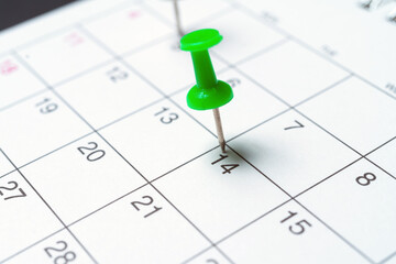Paper calendar with important day pushpin. Close up