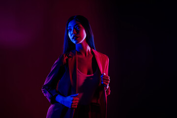 Portrait of gorgeous woman posing night club disco event isolated over dark red light shine color...