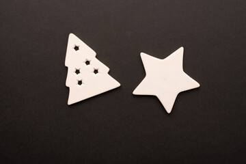 White star and Christmas tree made of ceramics on a dark background. Top view. Flat lay. 