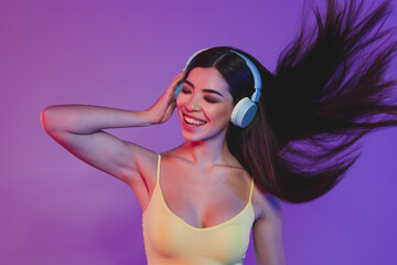 Portrait of charming cheerful dreamy girl listening hit soul bass single rock isolated over shine purple violet color background
