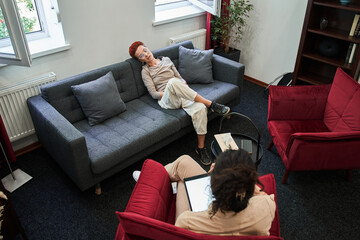 Therapist holding tablet and looking at her client woman with understanding