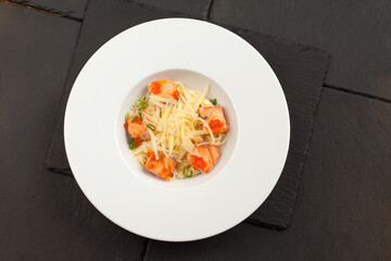 Salmon pasta on a plate. View from above.