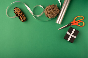 Christmas gift warping composition. Green background. Top view, flat lay