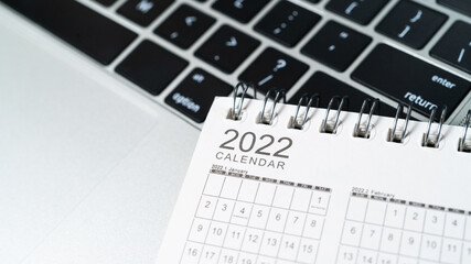 The inscription 2022 on a desk calendar on a keyboard background