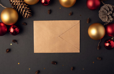 Craft envelope and Christmas decoration on a dark background. Flat lay. 