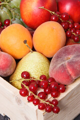 Fresh ripe fruits in wooden box. Food containing healthy minerals and vitamins