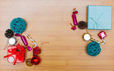 Christmas cluster high angle view gift boxes presented on rustic wooden floor. Gifts are scattered along the edges of the frame, leaving some space in the middle for your object or copy.
