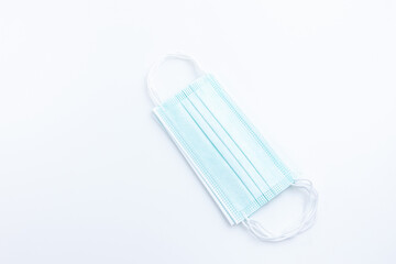 Top view medical mask isolated on white background with copy space. Concept wearing medical mask for protection virus, and distance.