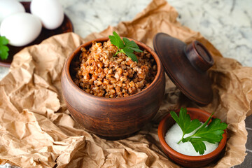 Buckwheat porridge with parsley in pot - breakfast, healthy food. Close up