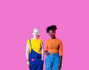 Two diverse women friends posing isolated advertising copy space background