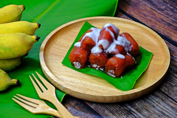 Cultivated banana in syrup with salted coconut cream. Authentic Thai dessert.