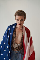 Patriotic young bisexual man wearing female clothes