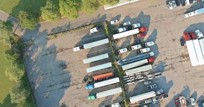 Panoramic view with rest area of truck stop of trucks trailers parked a row near US Interstate road