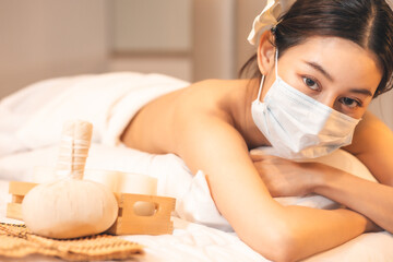 New normal lifestyle concept.Asian Beautiful, young and healthy woman in spa salon. Massage treatment spa room  Traditional medicine and healing concept.woman with face mask.