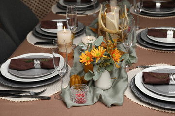 Table set with beautiful autumn decor for festive dinner