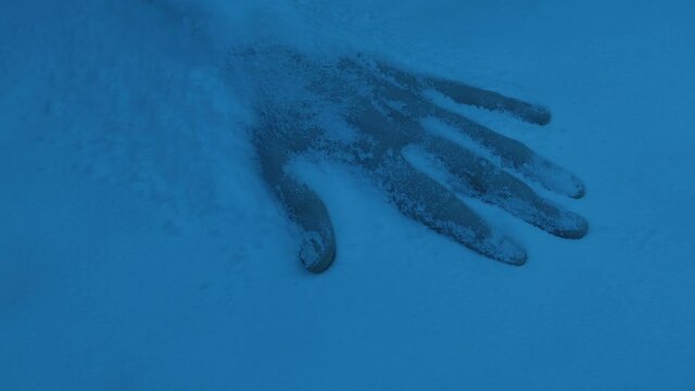 Hand Of Frozen Person In Snow In The Dark