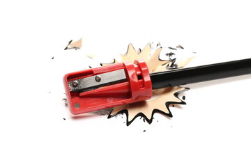 Graphite black pencil with plastic red sharpener and spiral shavings isolated on white background 