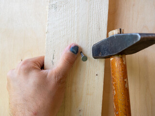 A close-up of an employee missed with a hammer and hit his finger. Bruise, hematoma, injury....