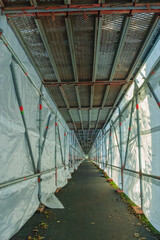 Scaffolding with tarpaulin over footpath