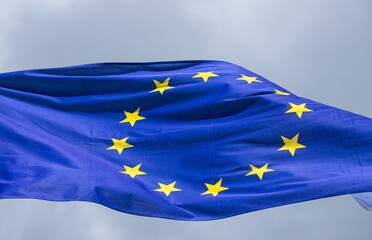 Official flag of the European Union in front of a blue sky