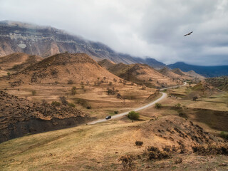 Fototapeta na wymiar Scenic winding road in red valley. Dramatic view of winding road in high mountain pass. Dagestan.