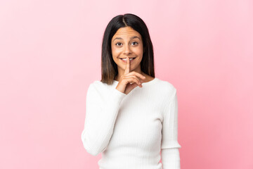 Caucasian girl isolated on pink background showing a sign of silence gesture putting finger in mouth