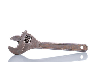 One old metal adjustable wrench, close-up, isolated on white.