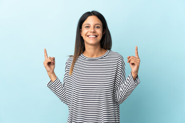 Caucasian girl isolated on blue background pointing up a great idea